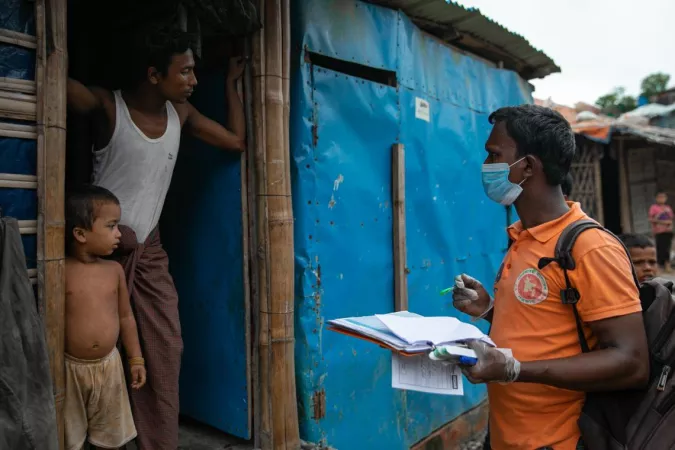 Bangladesh. A health worker meets a family.