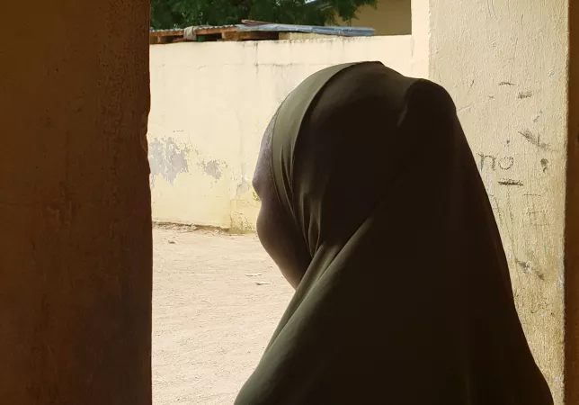 A girl looks out a window, Nigeria