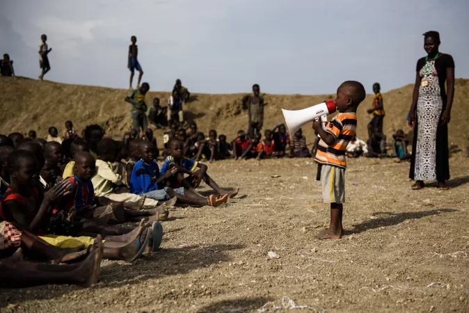 A young boy sings into a megaphone during a dance event organised at a child-friendly space run by UNICEF partner Woman Vision in the Protection of Civilians (PoC) site in Bentiu, South Sudan, 28 April 2017