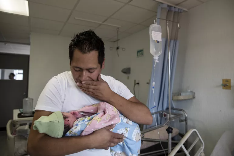 Yair Cruz, 26, holds his newborn baby girl Mia Gisele, his third child, at the Instituto Nacional de Perinatolog&iacute;a (INPER) hospital, in Mexico City, Mexico, Wednesday 21 February 2018.