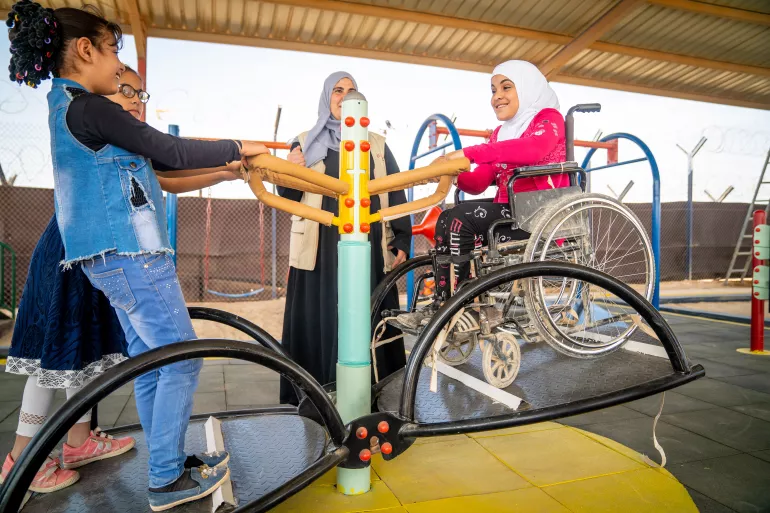 Amal, 9 years old, plays on the seesaw in the new inclusive playground in her school in Za&rsquo;atari Refugee Camp where she is in third grade. She is with Tasneem and Hala, both 10 years old. 