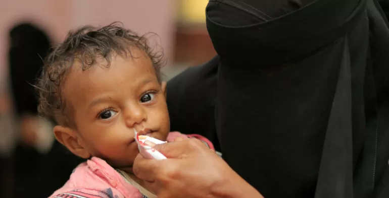 A young child receives therapeutic food