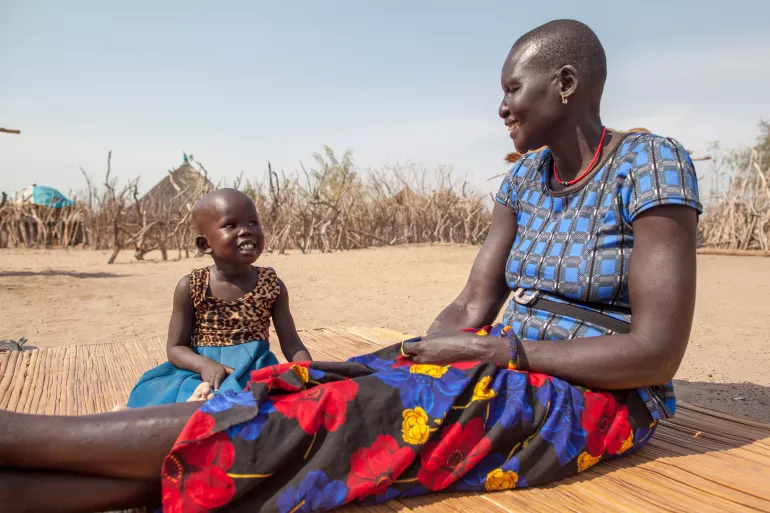 Deborah Yar and her 4 year old daughter, Nyanlei Thuch, are photographed in Guachateny Boma village in Jonglei State, South Sudan. Nyanlei - like many children in her community - receives medical assistance from Awan Agaan, a UNICEF-supported Bomi Health Worker.