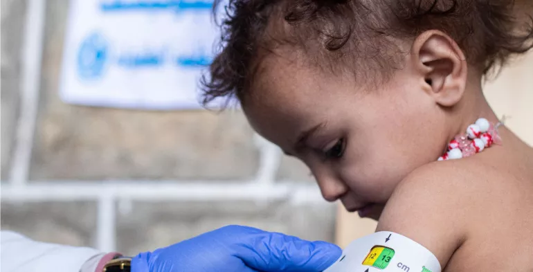 A child has their upper arm circumference measured