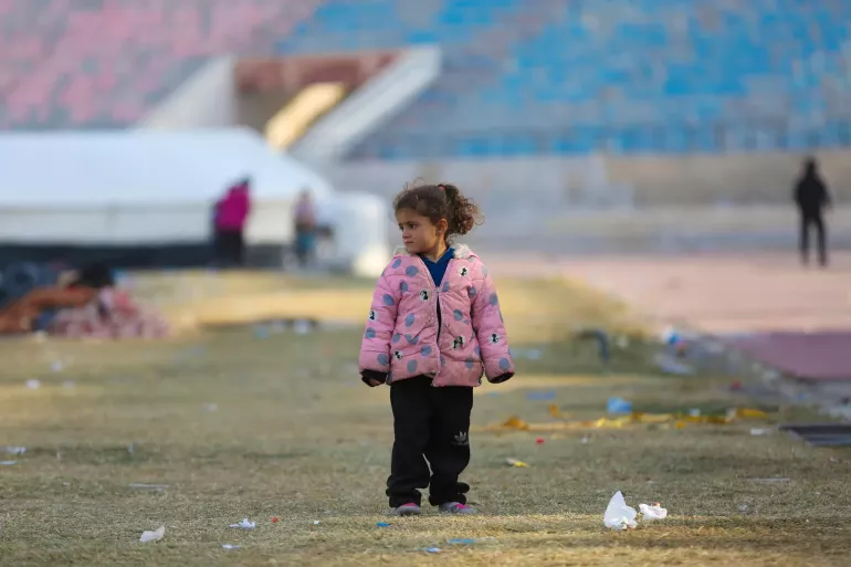 A young girl standing in the cold. &nbsp;She is among the newly arrived family at a reception centre in Ar-Raqqa city, Syria, on 4 December 2024, who fled the escalating violence in Aleppo