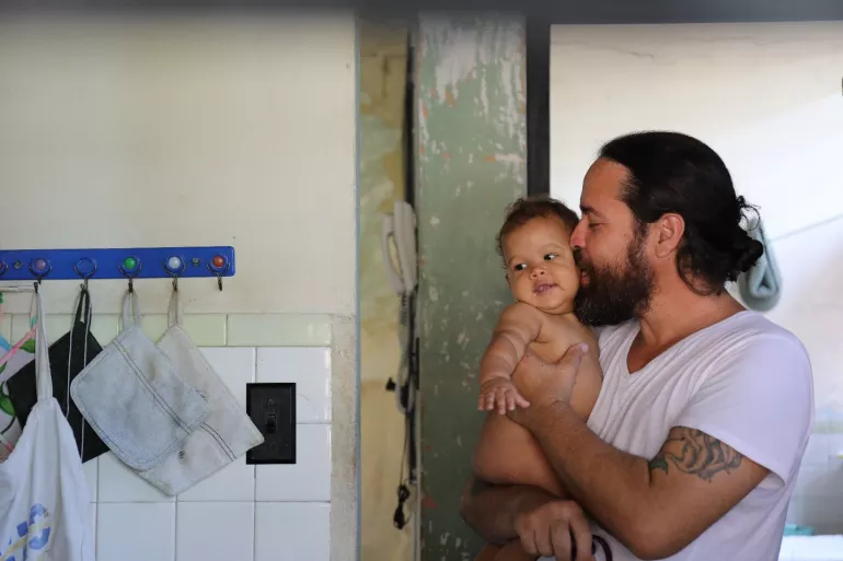 A father kisses his son, Cuba
