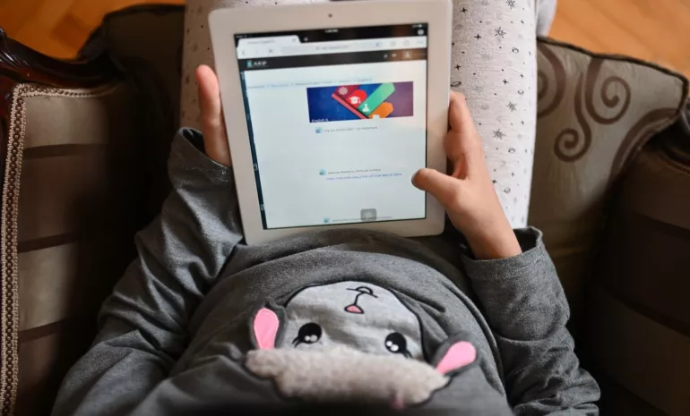 School girl using a tablet at home in Egypt