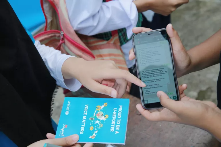 A young person In Indonesia demonstrates how to be U-Reporter and become agent of change using WhatsApp application