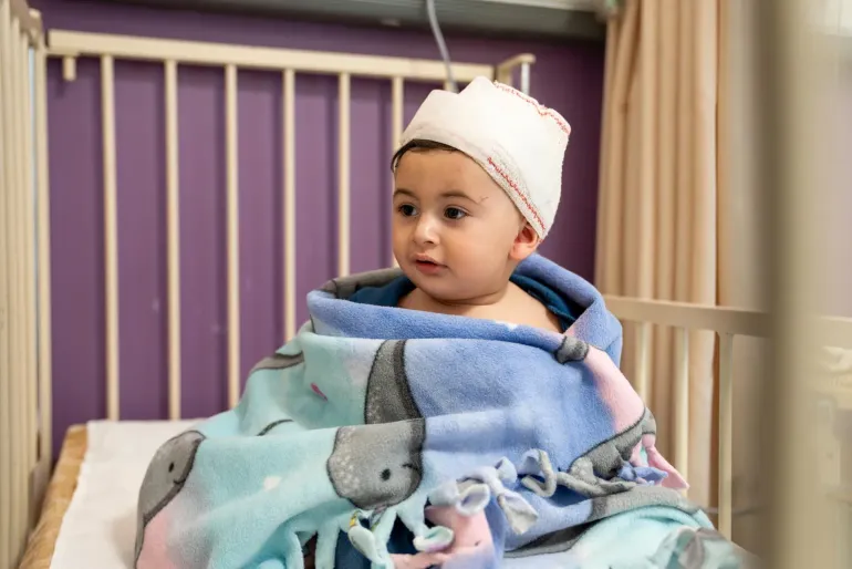 10-month-old Ahmad is held by his mother at Rafic Hariri Governmental Hospital in Beirut, after being injured in an Israeli airstrike that hit a home near theirs in southern Beirut on 8 April 2026. 