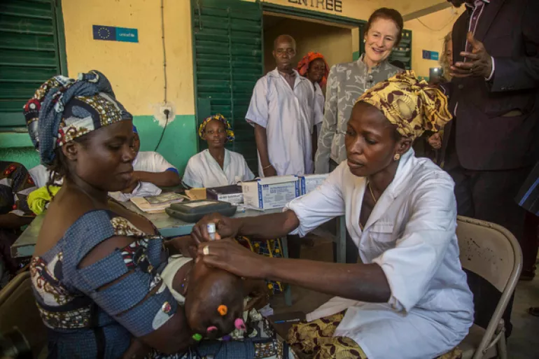 UNICEF Executive Director Henrietta H. Fore watches as a child receives a vaccination during her visit to the health centre in the suburbs of Bamako, the capital of Mali.