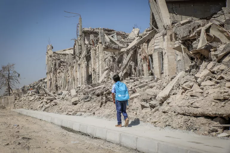 A child walks in West Mosul, Iraq.