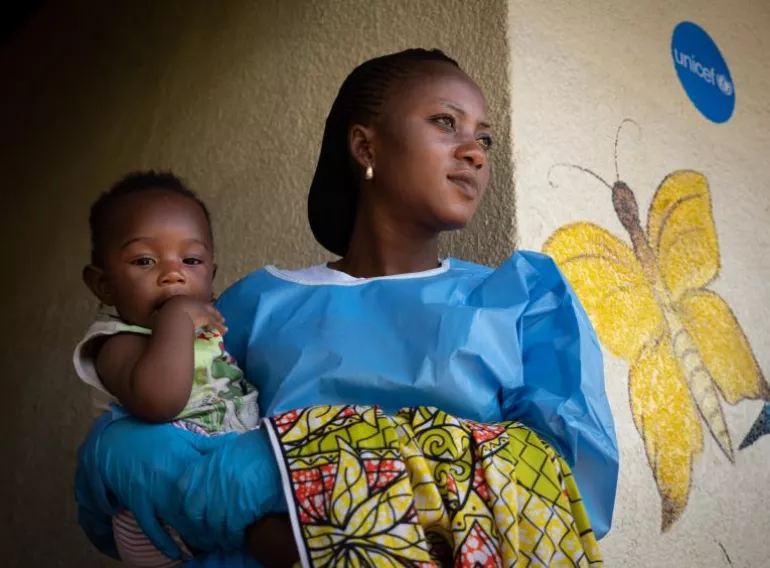 Jemima, an Ebola survivor, cares for a child at a UNICEF-supported cr&egrave;che in Beni, in eastern Democratic Republic of Congo.