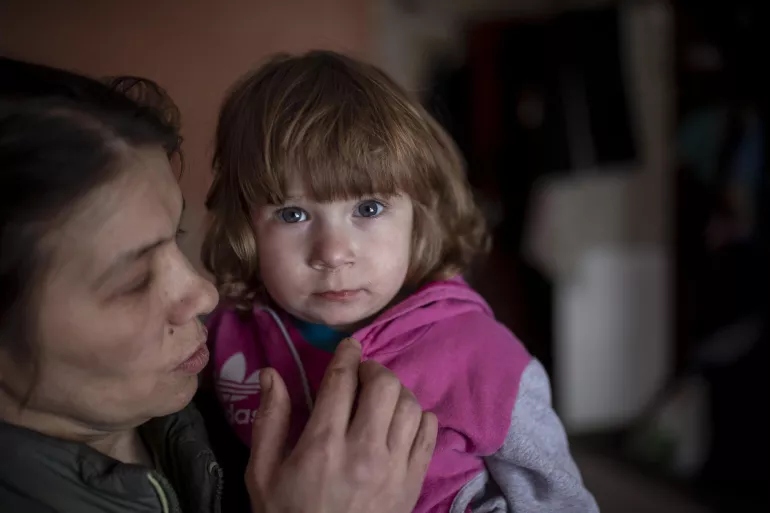 Ukraine. A woman holds her young daughter in eastern Ukraine.