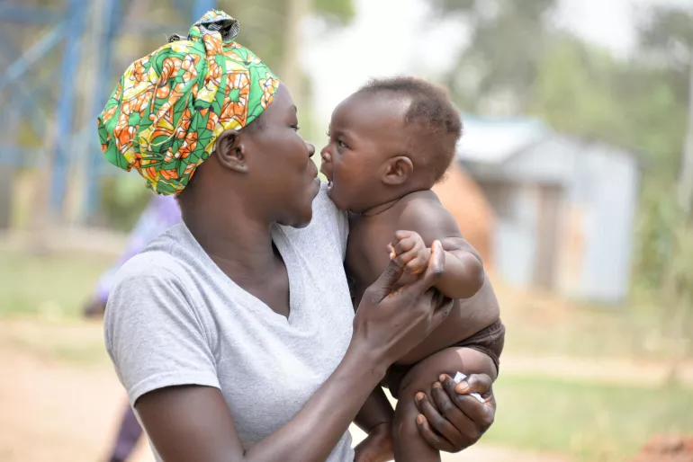 A mother holds her baby.