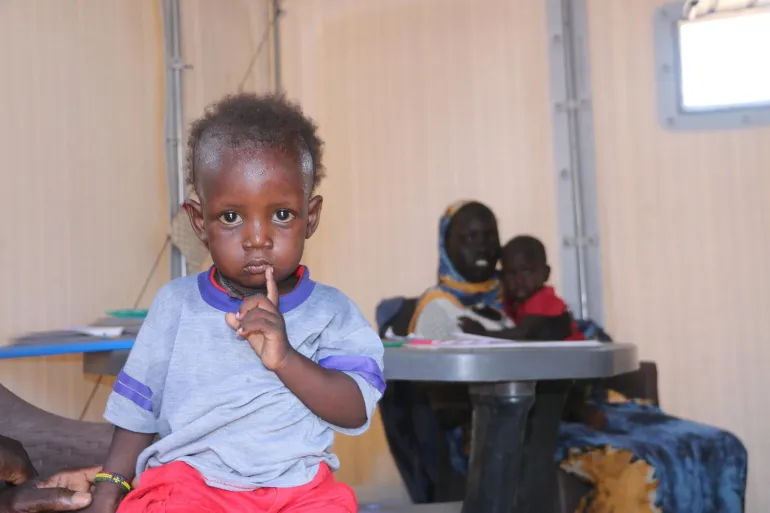 South Sudan. A child sits at a transit point transit point where UNICEF is providing health, nutrition, and child protection services in Upper Nile, South Sudan.
