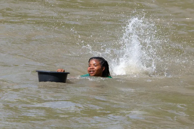 A girl swims to school in floodwaters in Papua New Guinea.