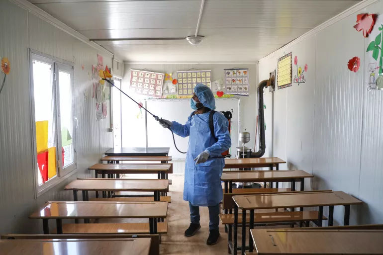 On 16 March 2020, near the Syrian town of Atme, close to the border with Turkey in Idlib province, a Syrian medical volunteer affiliated with a Turkish-registered Syrian relief organization sterilizes the inside of a make-shift classroom at a camp for displaced Syrians, as part of measures of COVID-19 coronavirus disease prevention.