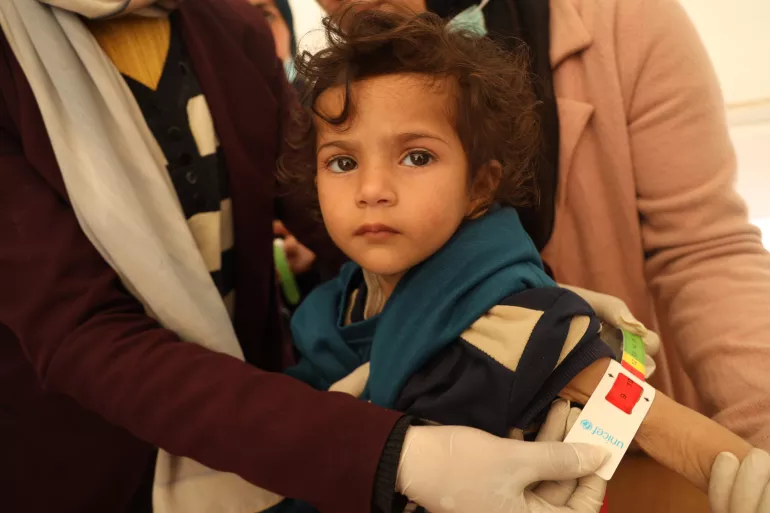 A child gets measured for malnutrition in the Gaza Strip