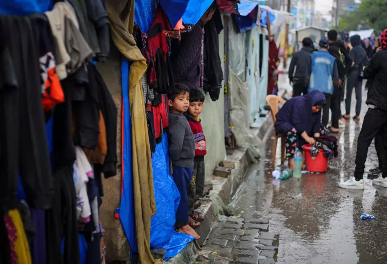 Gaza Strip. Children look out from a tent in Rafah.