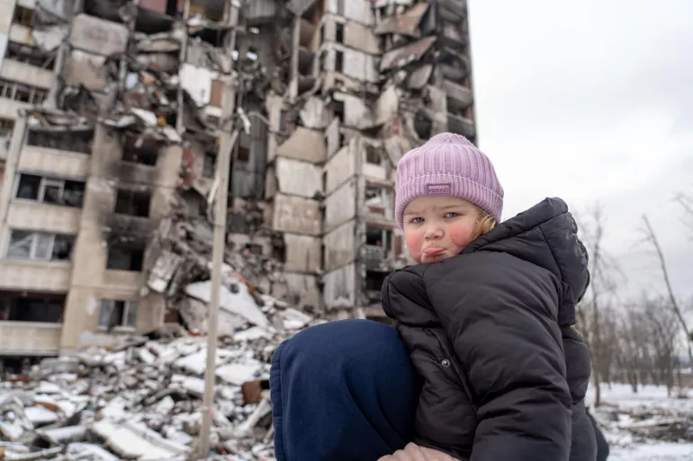Toddler with dad among the rubble in Saltivka, Ukraine