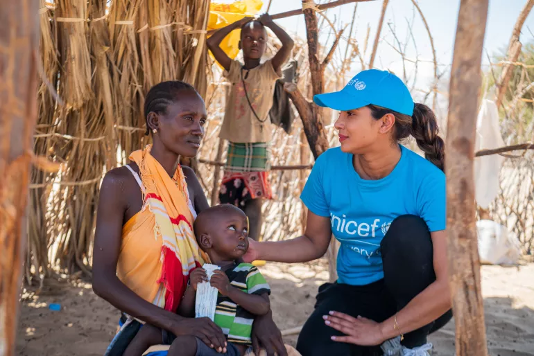 UNICEF Goodwill Ambassador Priyanka Chopra Jonas meets with 2-year-old Apolo Lokai who is being treated for malnutrition with a sachet of ready-to-use therapeutic food (RUTF). 