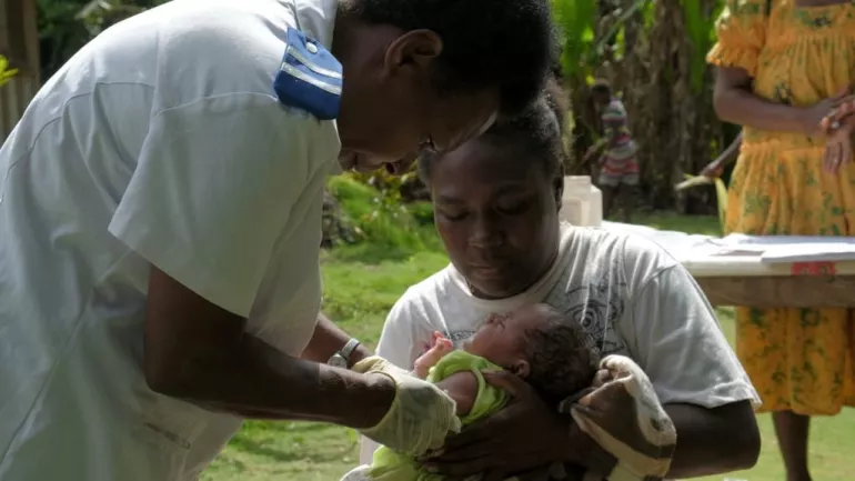 Registered nurse, Miriam Nampil, 55 years, vaccinates the first baby with a commercial drone delivered vaccine. Baby Joy Nowai, one month old, receives vaccines BCG to prevent tuberculosis and Hepatitis B.