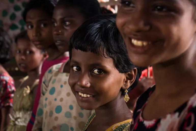 Children smile in a refugee camp in Bangladesh