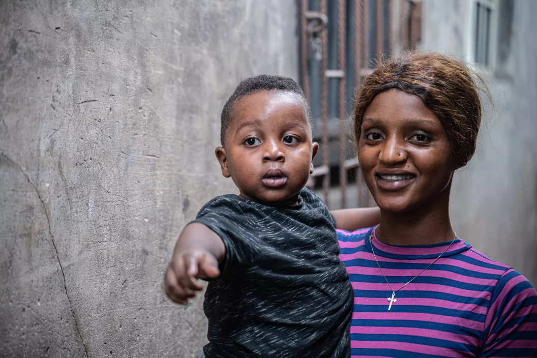 18-month old Zachariah Dimayin is held by his mother, Naomi Akinbami, outside of their home in Iwaya, a densely populated area of Lagos, Nigeria.