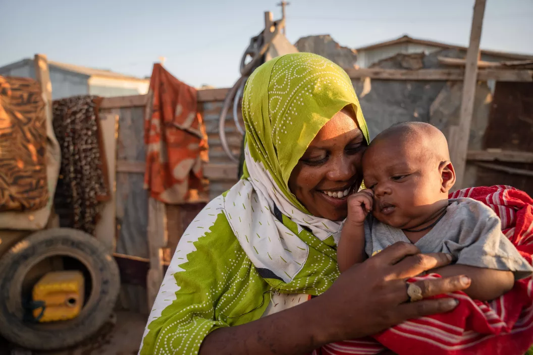 Une m&egrave;re tient son b&eacute;b&eacute; dans les bras