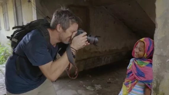 A photographer takes a photo of a girl