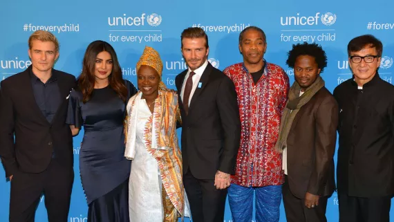 UNICEF Goodwill Ambassadors standing infront of a UNICEF branded backdrop