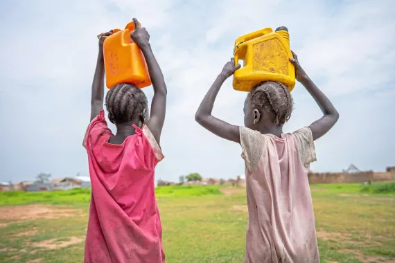 On the 31st July 2024, children carry&nbsp;water home in Renk town in South Sudan.