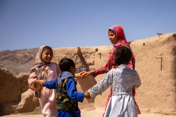 Children holding hands and dancing