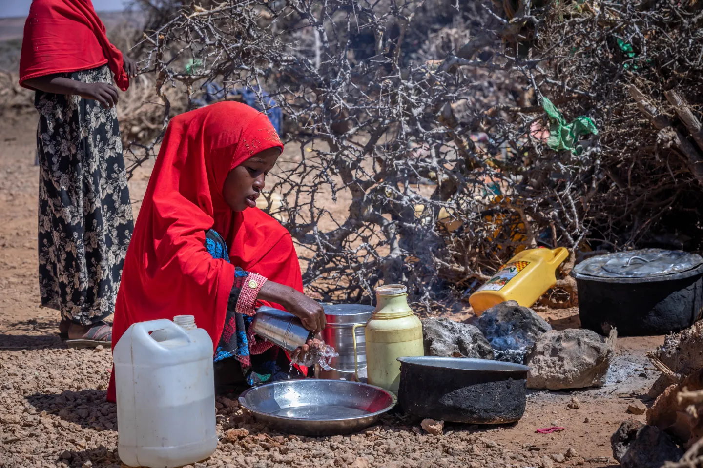 Fatume washes her hands before eating.