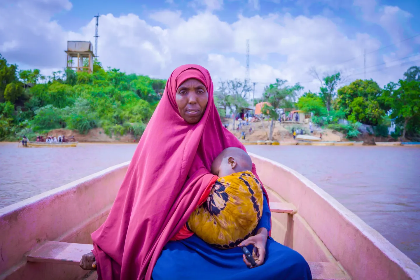 Asho Abdullahi travels by boat with her youngest child to a health centre in Bardhere.