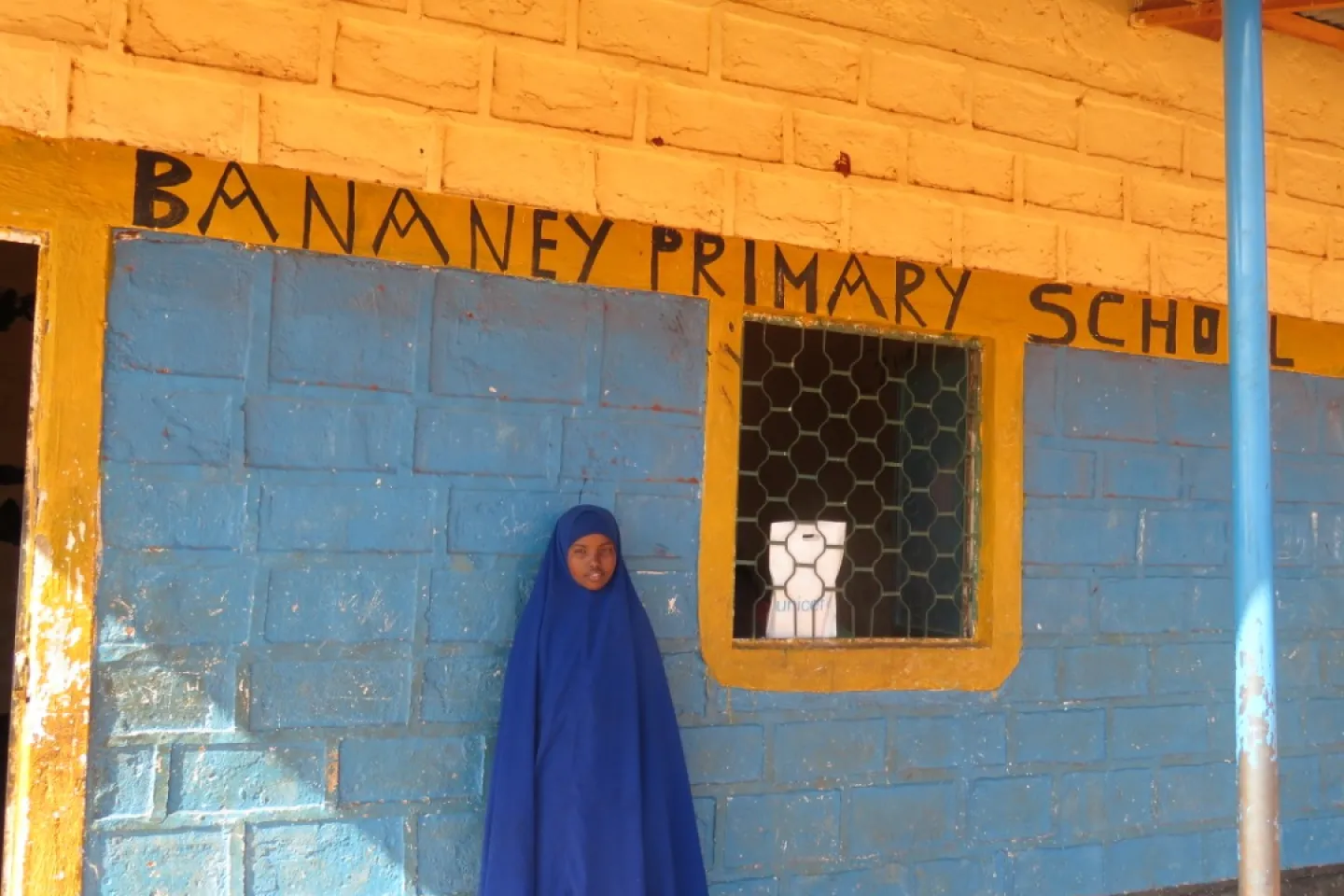 Kowsar standing outside her classroom 