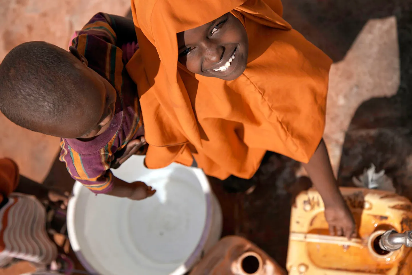 Mother-and-baby-collecting-water