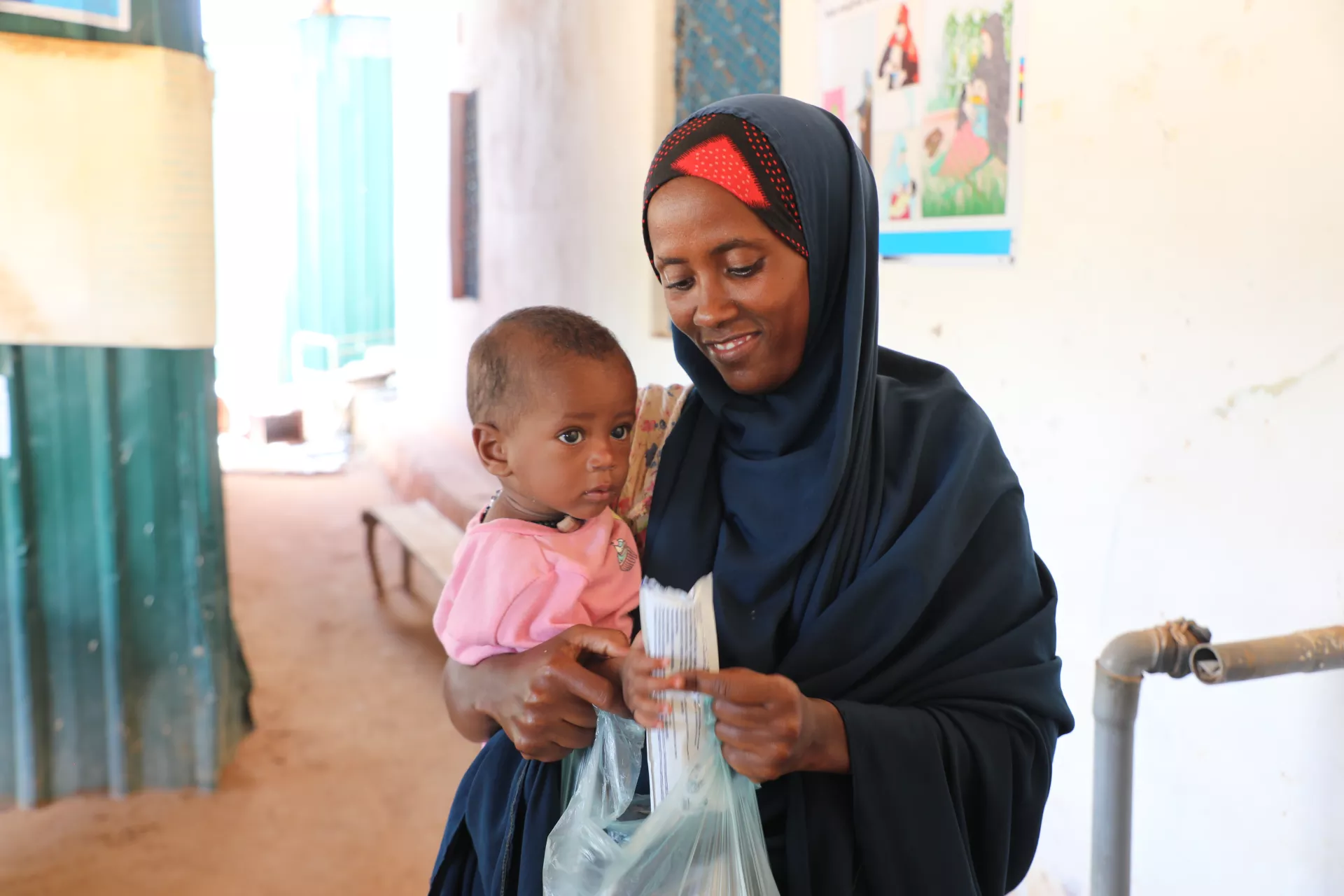 Halima with her baby at a nutrition site in Dollow