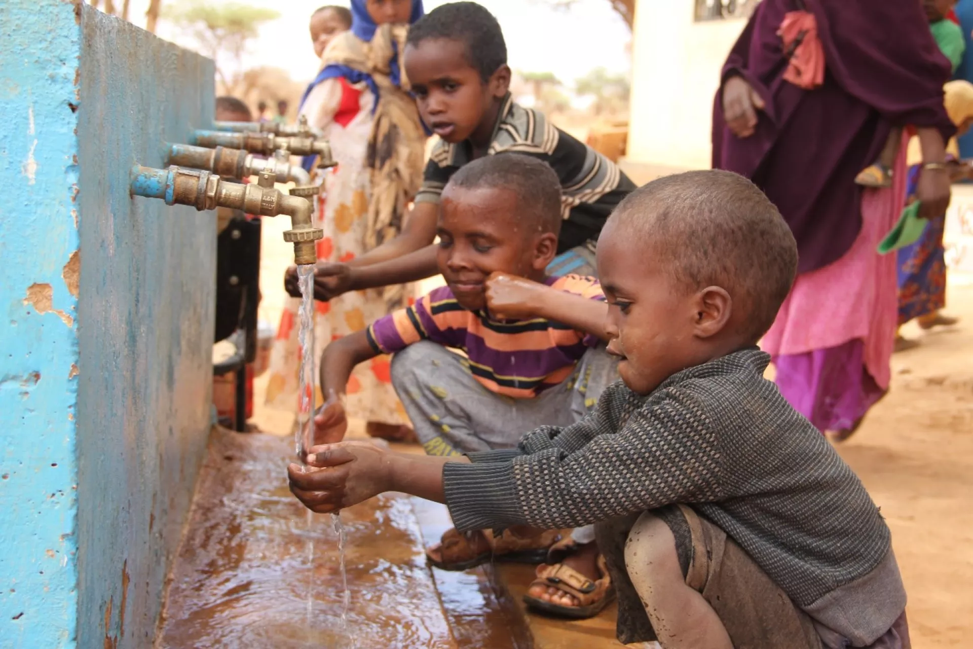 Children washing their hands.