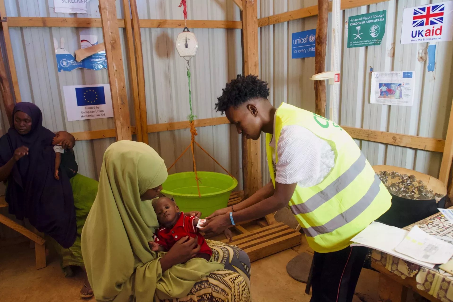 Deqa is having Ruweida's nutrition status checked.