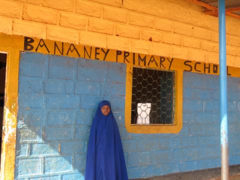 Kowsar standing outside her classroom 