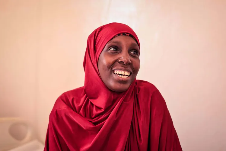 Nimo Abdi smiles inside Galkayo Health Centre, where access to quality maternal and newborn health services is helping mothers and babies thrive.