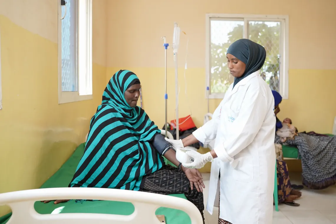 Hodan receives antenatal care at Eldheere Health Centre as midwife Huriyo Ahmed measures her blood pressure.