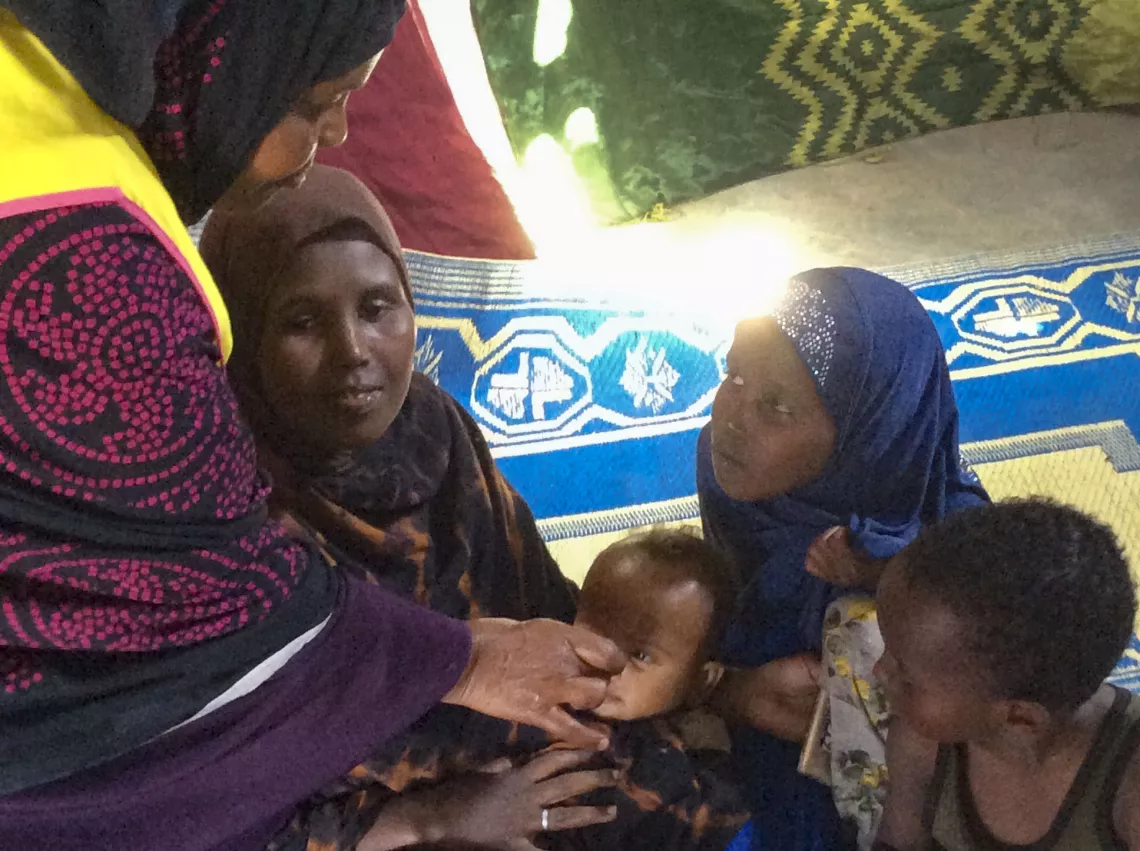 Mohamed is receiving polio drops.