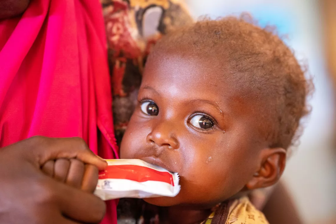 a child feeds on RUTF in a health centre in Dollow Somalia 