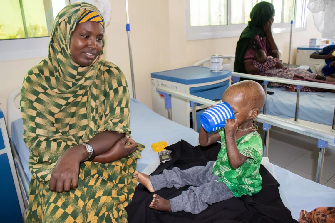 Salma enjoys the therapeutic milk that helps her recover from malnutrition.