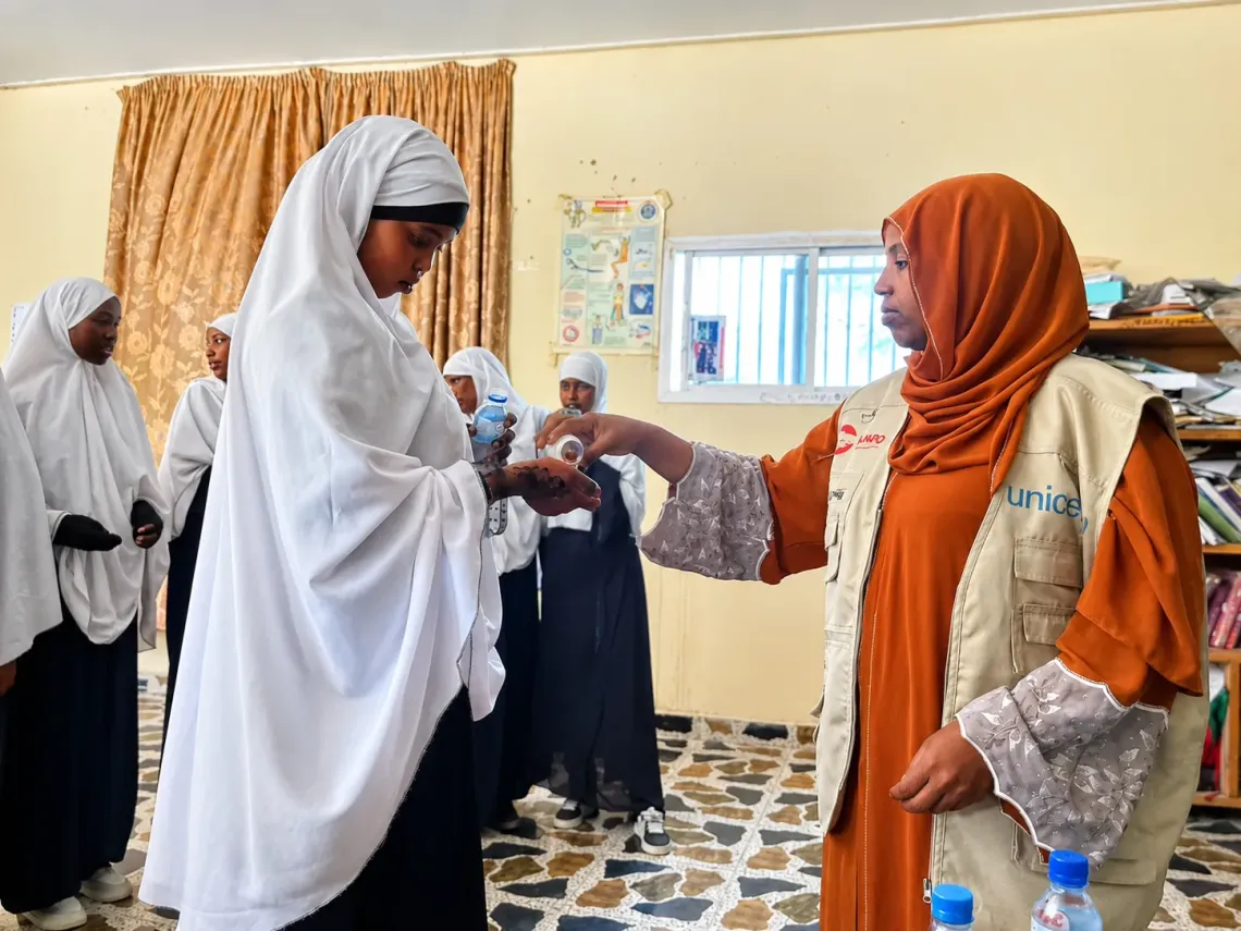 An adolescent girl receives an iron and folic acid supplement during a school-based health session at Dayib Guray Secondary School in Hargeisa.