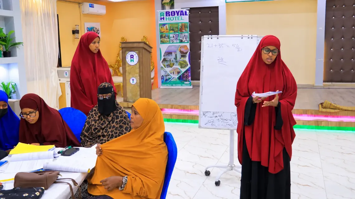 Sadia speaks in front of her classmates, putting into practice the confidence she has gained through the Girls Empowerment Forum.