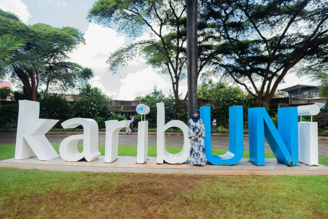 Sagal standing infront of the UN Signboard in UN GIGIRI IN NAIROBI