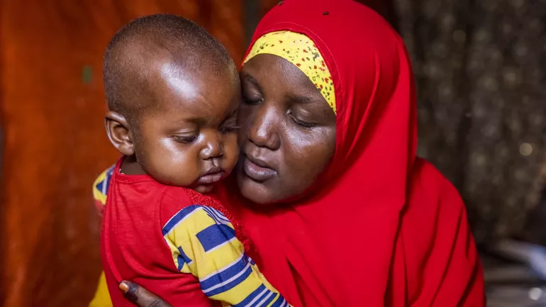 A mother holding her child. 